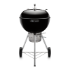 A Weber Master-Touch 22 Charcoal Grill on a black background.