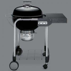 A charcoal grill on a grey background.