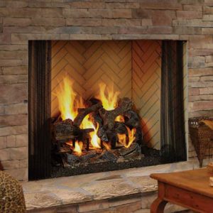 A living room with a Heatilator Birmingham Wood Burning Fireplace and logs in it.