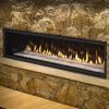 A Marquis Skyline III Direct Vent Fireplace with flames in the middle of a stone wall.