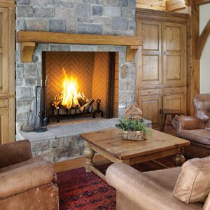 A living room with an Astria Plantation Wood Burning Fireplace.