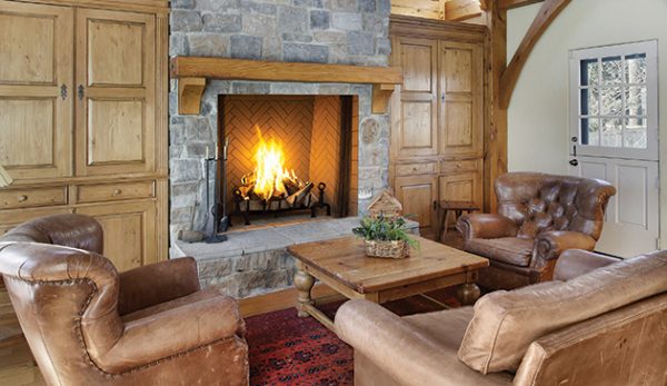 A living room with an Astria Plantation Wood Burning Fireplace.