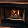 A Heatilator Accelerator Wood Burning Fireplace with a log set in it.