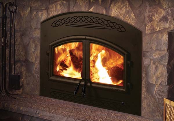 A Heatilator Constitution Wood Burning Fireplace in a stone fireplace.