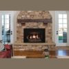 An Empire Rushmore Direct Vent Gas Insert in a living room with a stone mantel.