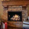 A living room with a Mendota Fullview direct fireplace and chairs.