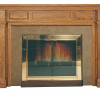 A fireplace with a TM Colonial Wood Mantel Surround and a fireplace insert.