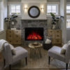 A living room with a Modern Flames Redstone Series Conventional Electric Fireplace Insert and chairs.