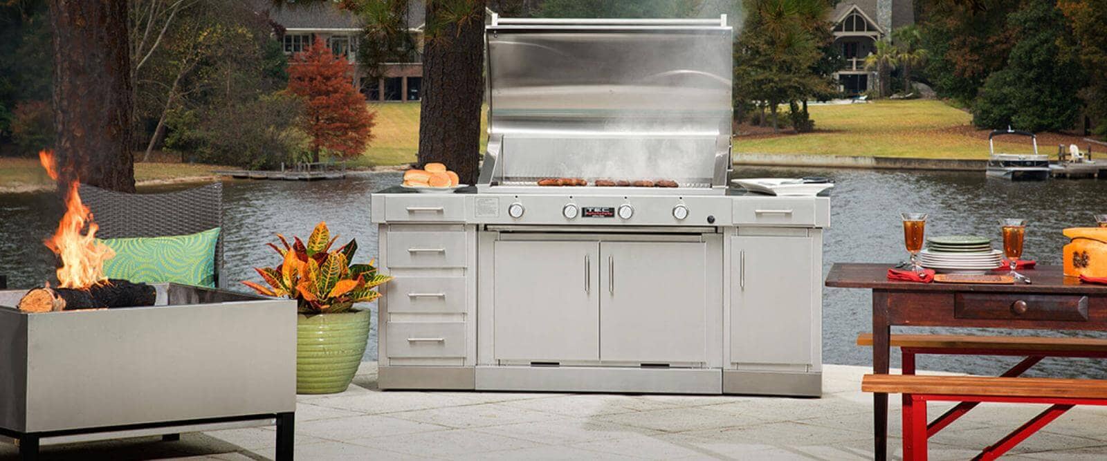 A gas grill and fire pit on a patio.