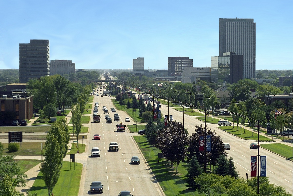 A city street with cars driving down it.