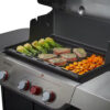 A Genesis Full-Size Griddle for Genesis 300 Grill with vegetables and meat on it.