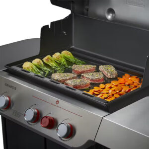 A Genesis Full-Size Griddle for Genesis 300 Grill with vegetables and meat on it.